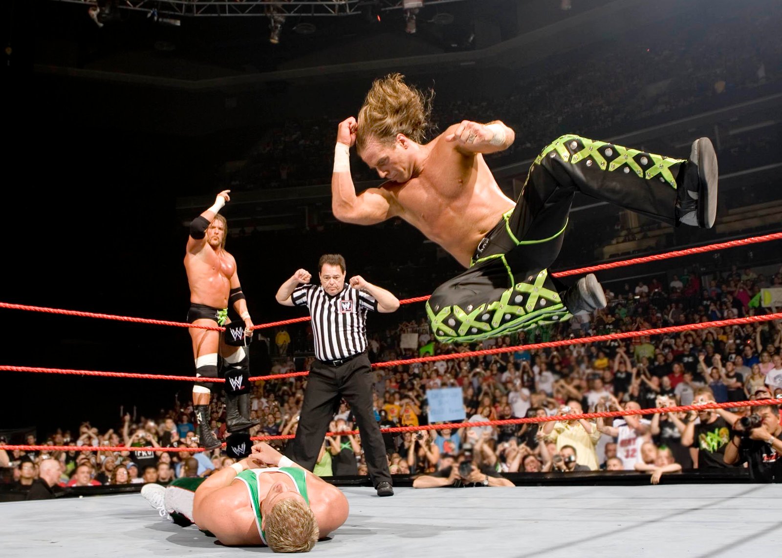 Shawn Michaels giving a huge elbow drop to a member of spirit squad.