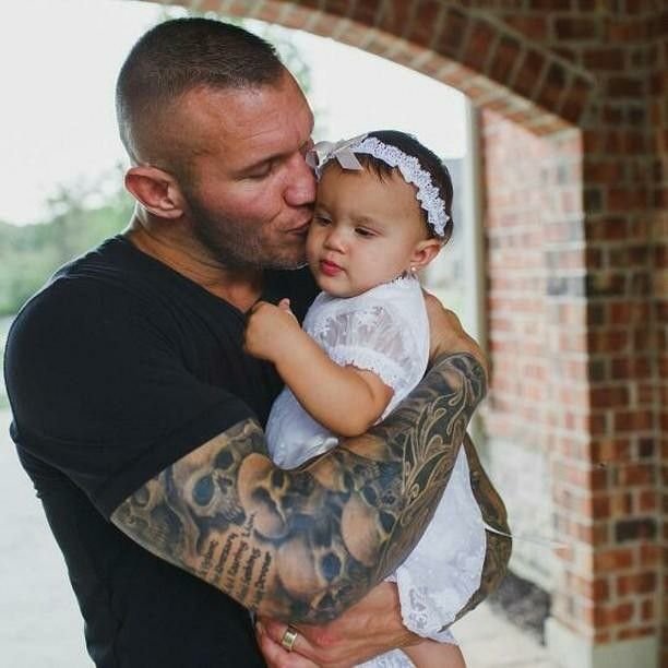 Randy Orton holding his daughter